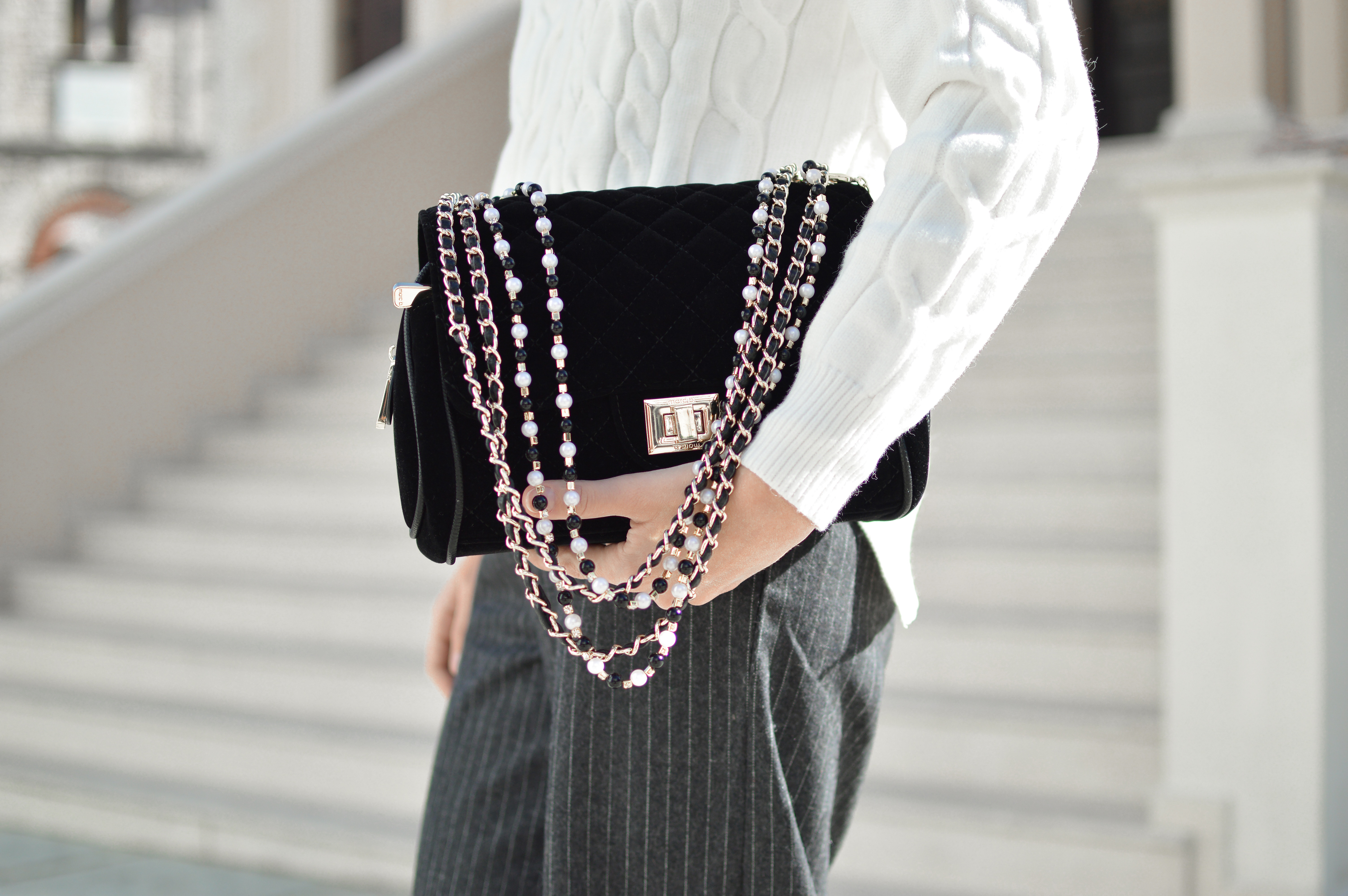 woman clutching handbag under arm